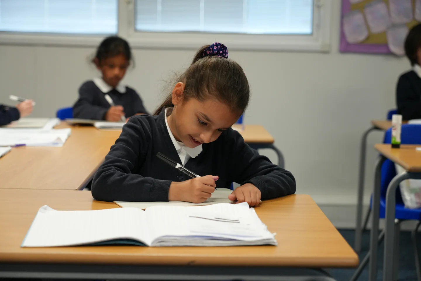 A pupil enjoying a writing activity at St John’s